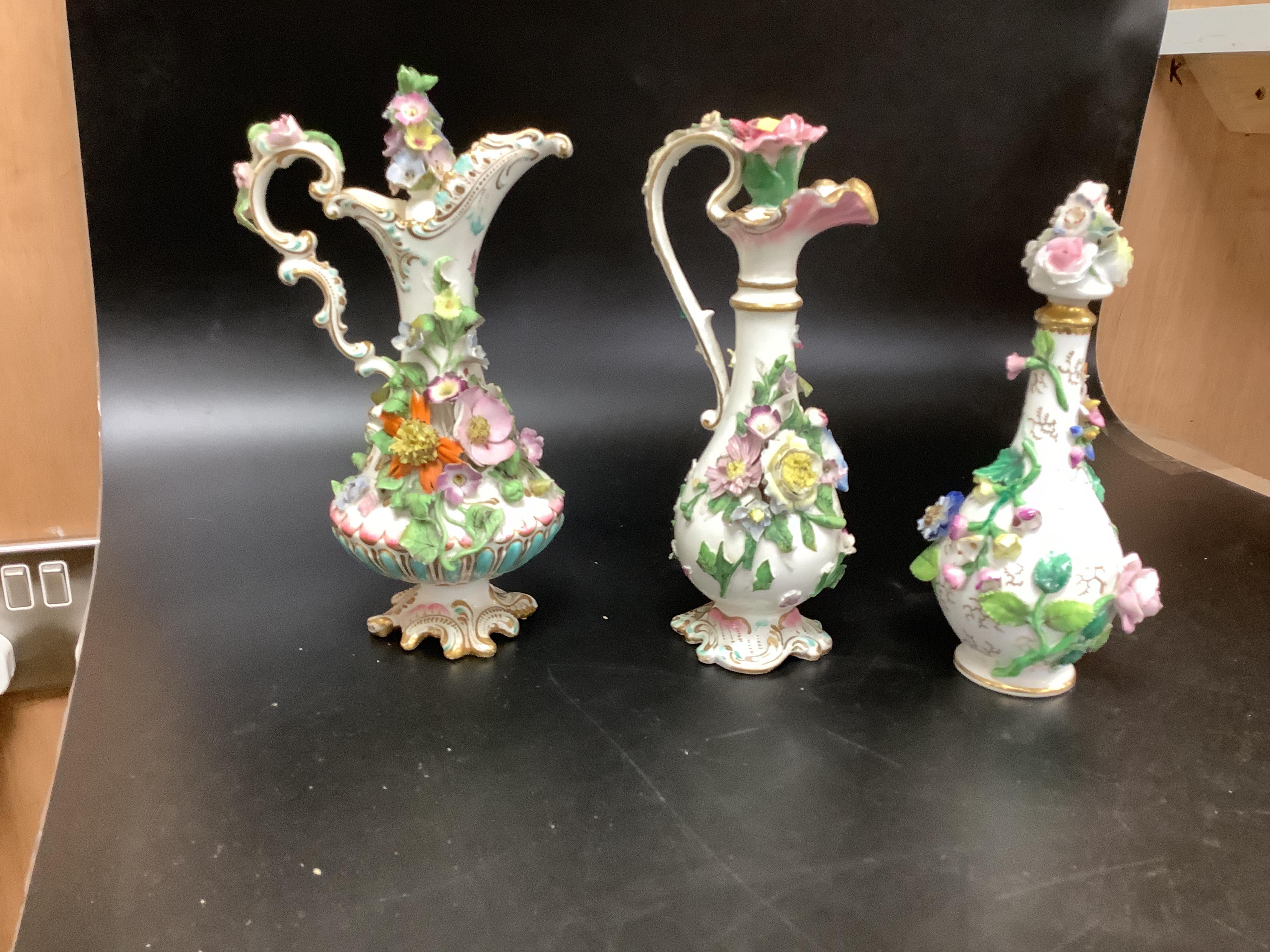 A group of English porcelain flower encrusted scent bottles and yours, Coalport, Minton etc., c.1830-50 together with Continental porcelain figures a wall pocket etc, largest 26cm high